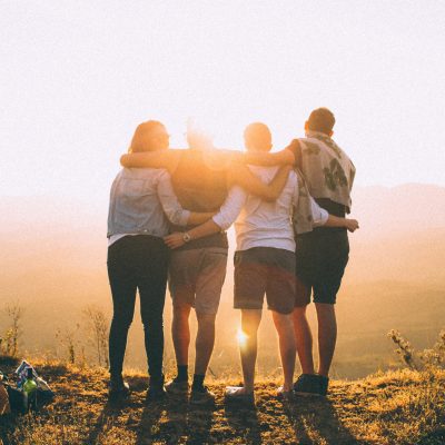 Canva - Four Person Standing on Cliff in Front of Sun